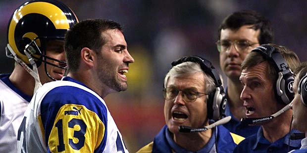 St. Louis Rams quarterback Kurt Warner talks to Rams head coach Dick Vermeil, at center, and other ...