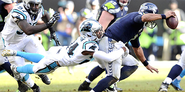 Carolina Panthers cornerback Josh Norman (24) tackles Seattle Seahawks quarterback Russell Wilson (...