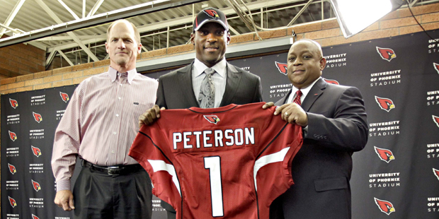 Arizona Cardinals' first-round draft pick Patrick Peterson, center, displays a jersey with head coa...
