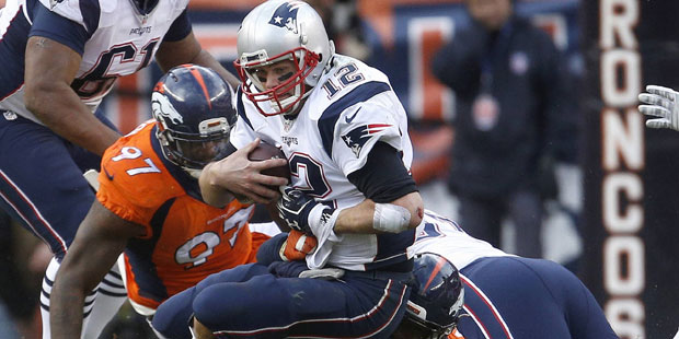New England Patriots quarterback Tom Brady is sacked by Denver Broncos outside linebacker Von Mille...