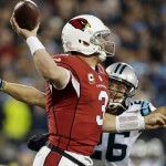 Arizona Cardinals' Carson Palmer (3) is hit by Carolina Panthers' Cortland Finnegan as he throws during the first half the NFL football NFC Championship game Sunday, Jan. 24, 2016, in Charlotte, N.C. (AP Photo/Bob Leverone)