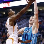 Charlotte Hornets' Cody Zeller (40) defends as Phoenix Suns' Brandon Knight, left, goes up for a shot during the second half of an NBA basketball game, Wednesday, Jan. 6, 2016, in Phoenix.  The Suns defeated the Hornets 111-102. (AP Photo/Ross D. Franklin)