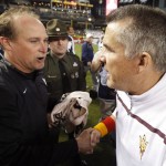West Virginia head coach Dana Holgorsen, left, and Arizona State head coach Todd Graham, right, meet on the field after the Cactus Bowl NCAA college football game Sunday, Jan. 3, 2016, in Phoenix. West Virginia won 43-42. (AP Photo/Ross D. Franklin)