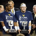 Offensive player of the game, West Virginia quarterback Skyler Howard, right, and defensive player of the game, West Virginia linebacker Shaq Petteway, left, hold their trophies after the Cactus Bowl NCAA college football game, Sunday, Jan. 3, 2016, in Phoenix. West Virginia won 43-42. (AP Photo/Matt York)
