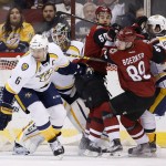 Nashville Predators' Shea Weber (6) looks for the puck as Arizona Coyotes' Mikkel Boedker (89), of Denmark, and Antoine Vermette (50) collide with Predators' Roman Josi, right, of Switzerland, in front of Predators goalie Carter Hutton, second from left, during the first period of an NHL hockey game Saturday, Jan. 9, 2016, in Glendale, Ariz. (AP Photo/Ross D. Franklin)