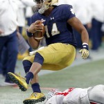 Notre Dame quarterback DeShone Kizer (14) is knocked out of bounds by Ohio State cornerback Eli Apple (13) during the second half of the Fiesta Bowl NCAA College football game, Friday, Jan. 1, 2016, in Glendale, Ariz.  (AP Photo/Rick Scuteri)