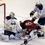 Buffalo Sabres goalie Chad Johnson (31) makes the save on Arizona Coyotes right wing Shane Doan (19) as defenseman Mike Weber (6) defends in the second period during an NHL hockey game, Monday, Jan. 18, 2016, in Glendale, Ariz. (AP Photo/Rick Scuteri)