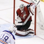 Edmonton Oilers' Justin Schultz (19) scores a goal against Arizona Coyotes' Louis Domingue, right, during the second period of an NHL hockey game Tuesday, Jan. 12, 2016, in Glendale, Ariz. (AP Photo/Ross D. Franklin)
