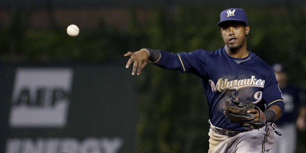 Milwaukee Brewers shortstop Jean Segura, right, throws out Chicago Cubs' Chris Coghlan at first bas...