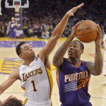 Phoenix Suns guard Archie Goodwin, right, goes up for a shot as Los Angeles Lakers guard D'Angelo Russell defends during the first half of an NBA basketball game, Sunday, Jan. 3, 2016, in Los Angeles. (AP Photo/Mark J. Terrill)