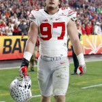 Ohio State defensive lineman Joey Bosa walks off the field after being ejected for targeting during the first half of the Fiesta Bowl NCAA College football game against Notre Dame, Friday, Jan. 1, 2016, in Glendale, Ariz.  (AP Photo/Rick Scuteri)
