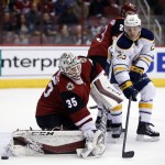 Arizona Coyotes goalie Louis Domingue (35) makes the save on Buffalo Sabres center Sam Reinhart in the first period during an NHL hockey game Monday, Jan. 18, 2016, in Glendale, Ariz. (AP Photo/Rick Scuteri)