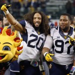 West Virginia's Edward Muldrow III (20) and Noble Nwachukwu (97) celebrate a win after the Cactus Bowl NCAA college football game against Arizona State, Sunday, Jan. 3, 2016, in Phoenix. West Virginia won 43-42. (AP Photo/Ross D. Franklin)