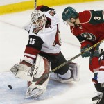 Minnesota Wild's Charlie Coyle, right, scores against Arizona Coyotes goalie Louis Domingue in the third period of an NHL hockey game, Monday, Jan. 25, 2016, in St. Paul, Minn. The Coyotes won 2-1 in a shootout. (AP Photo/Jim Mone)