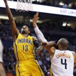 Indiana Pacers' Paul George (13) drives past Phoenix Suns' Tyson Chandler (4) for a score during the first half of an NBA basketball game, Tuesday, Jan. 19, 2016, in Phoenix. (AP Photo/Ross D. Franklin)