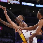 Los Angeles Lakers guard Jordan Clarkson, center, loses control of the ball as Phoenix Suns guard Sonny Weems, left, and guard Ronnie Price reach for it during the first half of an NBA basketball game, Sunday, Jan. 3, 2016, in Los Angeles. (AP Photo/Mark J. Terrill)