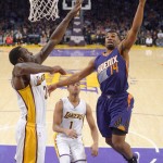Phoenix Suns guard Ronnie Price, right, shoots as Los Angeles Lakers forward Brandon Bass, left, defends along with guard D'Angelo Russell during the first half of an NBA basketball game Sunday, Jan. 3, 2016, in Los Angeles. (AP Photo/Mark J. Terrill)