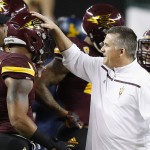 Arizona State coach Todd Graham, right, talks with DJ Calhoun (3) prior to the team's Cactus Bowl NCAA college football game against West Virginia on Saturday, Jan. 2, 2016, in Phoenix. (AP Photo/Ross D. Franklin)