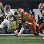 Alabama's Calvin Ridley, left, tries to run past Clemson's Adrian Baker during the first half of the NCAA college football playoff championship game Monday, Jan. 11, 2016, in Glendale, Ariz. (AP Photo/David J. Phillip)