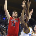 Arizona center Dusan Ristic, left, shoots as UCLA forward Tony Parker defends during the first half of an NCAA college basketball game, Thursday, Jan. 7, 2016, in Los Angeles. (AP Photo/Mark J. Terrill)
