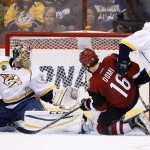 Nashville Predators' Carter Hutton, left, makes a save on a shot by Arizona Coyotes' Max Domi (16) as Predators' Filip Forsberg (9), of Sweden, defends during the third period of an NHL hockey game Saturday, Jan. 9, 2016, in Glendale, Ariz. The Coyotes defeated the Predators 4-0. (AP Photo/Ross D. Franklin)