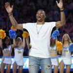 Former UCLA basketball player and current player for the Oklahoma Thunder Russell Westbrook fires up the crowd after being honored with a basketball court named after him following the first half of an NCAA college basketball game between UCLA and Arizona, Thursday, Jan. 7, 2016, in Los Angeles. (AP Photo/Mark J. Terrill)