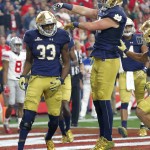 Notre Dame running back Josh Adams (33) celebrates his touchdown with Durham Smythe during the first half of the Fiesta Bowl NCAA College football game against Ohio State, Friday, Jan. 1, 2016, in Glendale, Ariz.  (AP Photo/Ross D. Franklin)