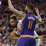 Boston Celtics center Jared Sullinger, left, looks to move around the defense of Phoenix Suns forward Markieff Morris (11) during the first quarter of an NBA basketball game Friday, Jan. 15, 2016, in Boston. (AP Photo/Stephan Savoia)