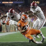 Clemson's Hunter Renfrow catches a touchdown pass in front of Alabama's Minkah Fitzpatrick and Eddie Jackson during the first half of the NCAA college football playoff championship game Monday, Jan. 11, 2016, in Glendale, Ariz. (AP Photo/David J. Phillip)