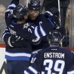 Winnipeg Jets' Nikolaj Ehlers (27), Blake Wheeler (26) and Toby Enstrom (39) celebrate after Ehlers scored his second goal of the period against the Arizona Coyotes in an NHL hockey game Tuesday, Jan 26, 2016, in Winnipeg, Manitoba. (Trevor Hagan/The Canadian Press via AP)