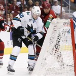 San Jose Sharks' Chris Tierney (50) stuffs the puck in for a goal as Arizona Coyotes' Nicklas Grossmann (2), of Sweden, and Viktor Tikhonov (9), of Russia, defend and Sharks' Melker Karlsson (68), of Sweden, falls into the goal during the first period of an NHL hockey game, Thursday, Jan. 21, 2016, in Glendale, Ariz. (AP Photo/Ross D. Franklin)