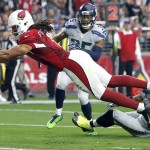 Arizona Cardinals wide receiver Larry Fitzgerald (11) scores a touchdown against the Seattle Seahawks during the first half of an NFL football game, Sunday, Jan. 3, 2016, in Glendale, Ariz. (AP Photo/Rick Scuteri)