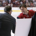 Arizona Coyotes' Shane Doan, right, smiles as he shakes hands with co-owner Anthony LeBlanc, left, as Doan is recognized for becoming the franchise leader for goals, with his 380th, during ceremonies prior to an NHL hockey game against the San Jose Sharks, Thursday, Jan. 21, 2016, in Glendale, Ariz. (AP Photo/Ross D. Franklin)