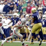 Ohio State defensive lineman Joey Bosa (97) leans in before hitting Notre Dame quarterback DeShone Kizer (14) during the first half of the Fiesta Bowl NCAA College football game, Friday, Jan. 1, 2016, in Glendale, Ariz. Bosa was ejected for targeting Kizer on the play. (AP Photo/Rick Scuteri)