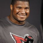Arizona Cardinals' Calais Campbell smiles as he is asked a question about Carolina Panthers quarterback Cam Newton during a news conference at the Cardinals NFL football training facility Wednesday, Jan. 20, 2016, in Tempe, Ariz.  The Cardinals will face the Panthers in the NFC Championship game on Sunday in Charlotte, N.C. (AP Photo/Ross D. Franklin)