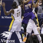 Phoenix Suns guard Lorenzo Brown (41) grabs a rebound over Indiana Pacers center Jordan Hill (27) during the first half of an NBA basketball game in Indianapolis, Tuesday, Jan. 12, 2016. (AP Photo/Michael Conroy)