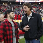 Washington Nationals' baseball player Bryce Harper, left, talks with Hall of Famer Randy Johnson prior to the Fiesta Bowl NCAA College football game between Notre Dame and Ohio State , Friday, Jan. 1, 2016, in Glendale, Ariz.  (AP Photo/Ross D. Franklin)