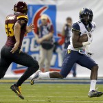 West Virginia safety KJ Dillon (9) runs after an interception as Arizona State's Mitchell Fraboni (63) pursues during the first half of the Cactus Bowl NCAA college football game, Saturday, Jan. 2, 2016, in Phoenix. (AP Photo/Ross D. Franklin)