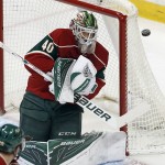 Minnesota Wild goalie Devan Dubnyk deflects a shot in the first period of an NHL hockey game against the Arizona Coyotes, Monday, Jan. 25, 2016, in St. Paul, Minn. (AP Photo/Jim Mone)