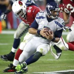 Seattle Seahawks quarterback Russell Wilson (3) is sacked by Arizona Cardinals inside linebacker Dwight Freeney (54) during the second half of an NFL football game, Sunday, Jan. 3, 2016, in Glendale, Ariz. (AP Photo/Rick Scuteri)