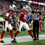 Arizona Cardinals wide receiver Michael Floyd (15) celebrates his touchdown catch with teammate  J.J. Nelson (14) during the first half of an NFL divisional playoff football game, Saturday, Jan. 16, 2016, in Glendale, Ariz. (AP Photo/Ross D. Franklin)
