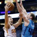Phoenix Suns' Mirza Teletovic, left, of Bosnia, drives past Charlotte Hornets' Cody Zeller, right, during the second half of an NBA basketball game, Wednesday, Jan. 6, 2016, in Phoenix. The Suns defeated the Hornets 111-102. (AP Photo/Ross D. Franklin)