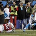 Carolina Panthers' Ted Ginn gets past Arizona Cardinals' Justin Bethel for a touchdown run during the first half the NFL football NFC Championship game Sunday, Jan. 24, 2016, in Charlotte, N.C. (AP Photo/Chuck Burton)