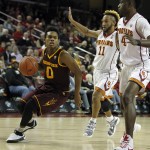 Arizona State guard Tra Holder (0) drives to the basket against Southern California guard Jordan McLaughlin (11) and forward Chimezie Metu (4) during the first half of an NCAA college basketball game in Los Angeles, Thursday, Jan. 7, 2016. (AP Photo/Alex Gallardo)
