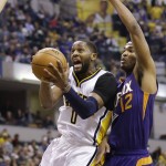 Indiana Pacers forward C.J. Miles (0) shoots in front of Phoenix Suns forward T.J. Warren (12) during the first half of an NBA basketball game in Indianapolis, Tuesday, Jan. 12, 2016. (AP Photo/Michael Conroy)