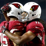 Arizona Cardinals wide receiver Michael Floyd (15) celebrates his touchdown catch with teammate  Larry Fitzgerald (11) during the first half of an NFL divisional playoff football game against the Green Bay Packers, Saturday, Jan. 16, 2016, in Glendale, Ariz. (AP Photo/Ross D. Franklin)