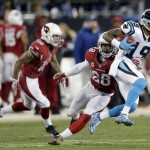 Arizona Cardinals' Justin Bethel (28) tries to stop Carolina Panthers' Ted Ginn after a catch during the first half the NFL football NFC Championship game Sunday, Jan. 24, 2016, in Charlotte, N.C. (AP Photo/Chuck Burton)