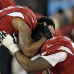 Arizona Cardinals' Patrick Peterson (21) consoles Frostee Rucker during the second half the NFL football NFC Championship game against the Carolina Panthers Sunday, Jan. 24, 2016, in Charlotte, N.C. (AP Photo/Bob Leverone)