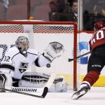 Los Angeles Kings' Jonathan Quick (32) reaches up to make a save on a shot by Arizona Coyotes' Antoine Vermette, right, during the first period of an NHL hockey game Saturday, Jan. 23, 2016, in Glendale, Ariz. (AP Photo/Ross D. Franklin)