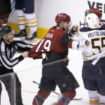 Arizona Coyotes right wing Shane Doan (19) is held back from going after Buffalo Sabres defenseman Rasmus Ristolainen after losing 2-1 during an NHL hockey game, Monday, Jan. 18, 2016, in Glendale, Ariz. (AP Photo/Rick Scuteri)
